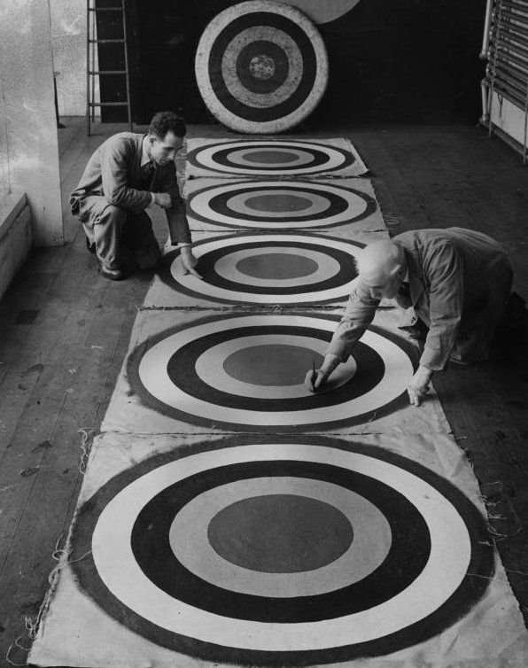 Bowmaker Mr W Law and his son examine archery targets in their Edinburgh workshop