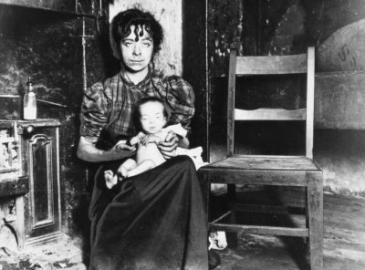 A young mother in a slum kitchen probably in about 1890