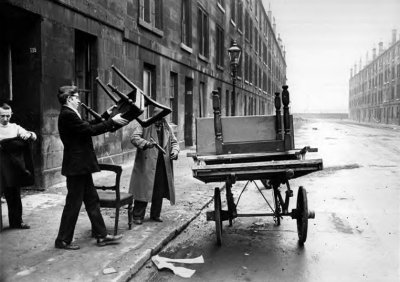Man piling furniture onto a cart, Gorbals