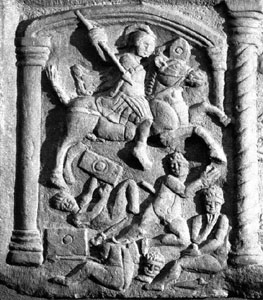 Photograph of part of the Bridgeness Slab, showing a Roman cavalryman riding down a native.